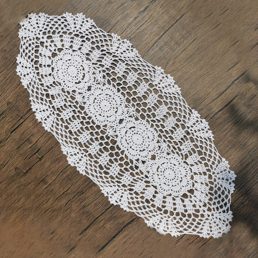 12x24 inch White crocheted doily on a wooden surface