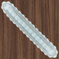 12x63 inch White lace doily on a wooden surface