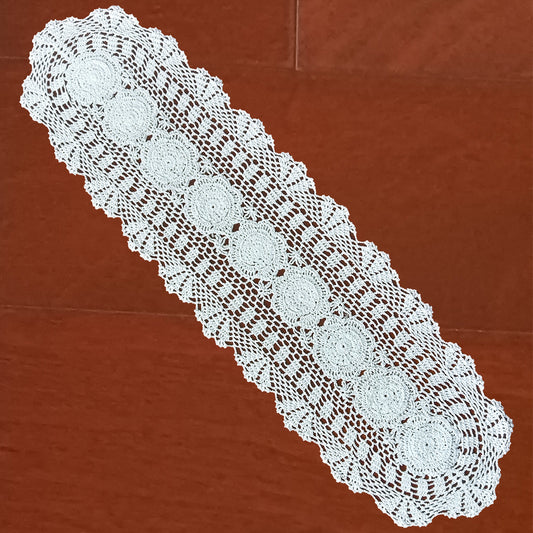 12x48 inch White lace table runner on a wooden surface