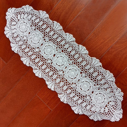 12x35 White crocheted table runner on a wooden floor