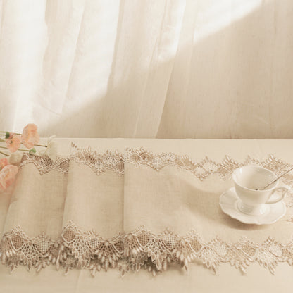 Lace tablecloth with a cup and saucer on a table, soft focus background