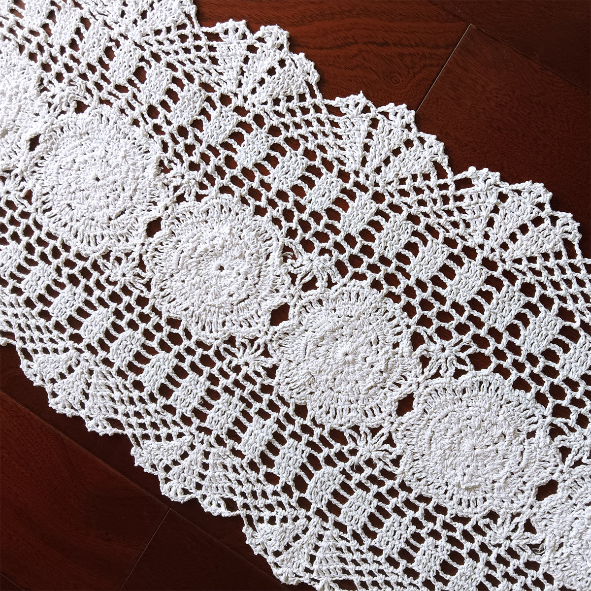 White crocheted doily on a wooden surface