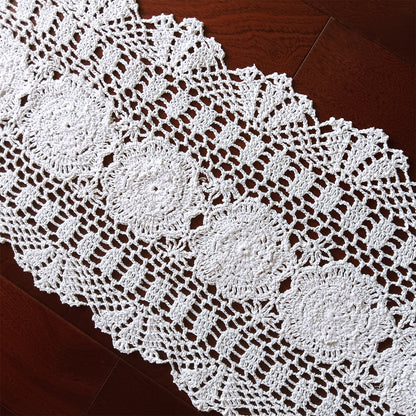 White crocheted doily on a wooden surface